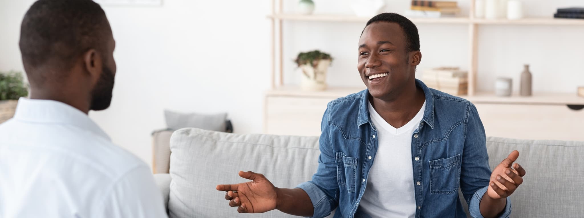 Man smiling and speaking openly during a therapy session β the openness and relief that comes with good psychiatric care